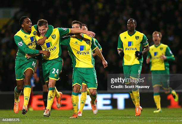 Leroy Fer of Norwich City congratulates Ryan Bennett of Norwich City on scoring their first goal during the Barclays Premier League match between...