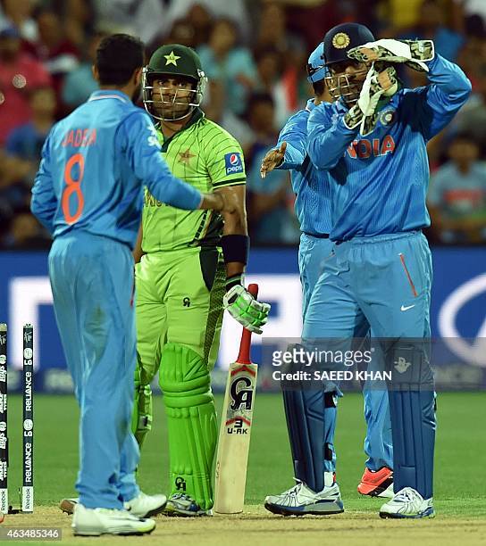 India's wicketkeeper Mahendra Singh Dhoni request for third umpire decision of Pakistan's Umar Akmal catch during the Pool B 2015 Cricket World Cup...