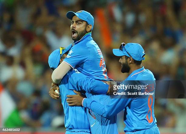 Virat Kohli of India is lifted in the air by Ravindra Jadeja after taking a catch to dismiss Shahid Afridi of Pakistan during the 2015 ICC Cricket...