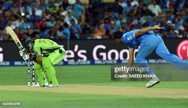 Pakistan's batsman Misbah-ul Haq ducks to avoid a bouncer by India's paceman Mohammed Shami during the Pool B 2015 Cricket World Cup match between...