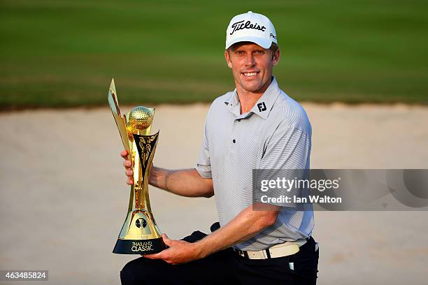 Andrew Dodt of Australia poses with the trophy after victory in the 2015 True Thailand Classic at Black Mountain Golf Club on February 15, 2015 in...