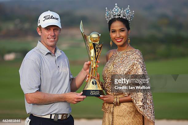 Andrew Dodt of Australia celebrates with the trophy and Nantawan Thongleng miss Thailand after winning the final round of the 2015 True Thailand...
