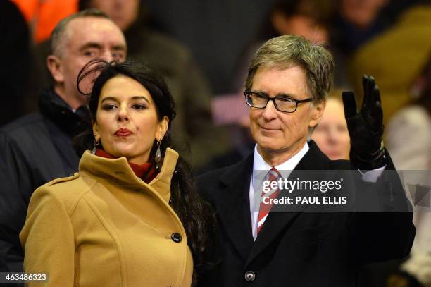 Liverpool's US owner John W Henry and wife Linda Pizzuti arrive to watch the English Premier League football match between Liverpool and Aston Villa...