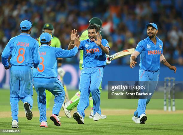 Mohammed Shami of India celebrates with his teammates after dismissing Wahab Riaz of Pakistan during the 2015 ICC Cricket World Cup match between...