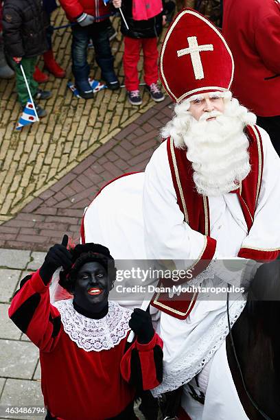 People line the streets near the pier as Sint Piter, named after the patron saint of fishermen Saint Peter, and Zwarte Piet arrive much to the...