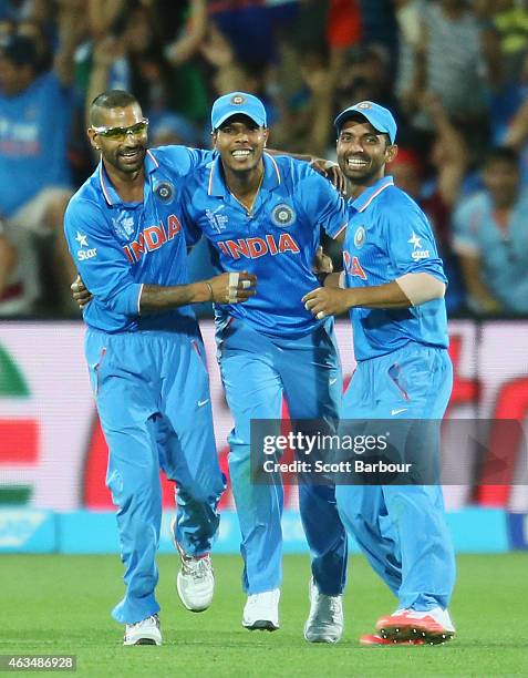 Umesh Yadav of India celebrates with Shikhar Dhawan and Ajinkya Rahane after taking a catch to dismiss Sohail Khan of Pakistan and win the match...