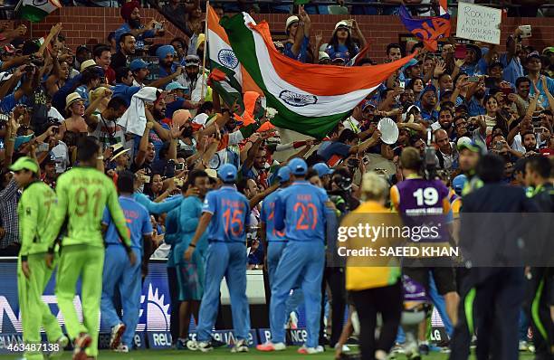 Spectators celebrate India's victory over Pakistan in the Pool B 2015 Cricket World Cup match between India and Pakistan at the Adelaide Oval on...