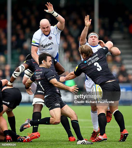 Matt Garvey and Henry Thomas of Bath try to block a kick by Neil De Kock of Saracens during the Aviva Premiership match between Saracens and Bath...