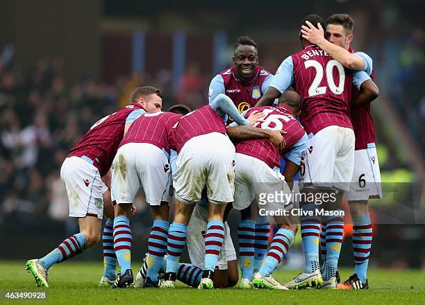 Leandro Bacuna of Aston Villa is mobbed by team mates as he celebrates scoring the opening goal during the FA Cup fifth round match between Aston...
