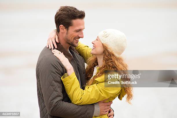 young couple embracing - short guy tall woman stock pictures, royalty-free photos & images