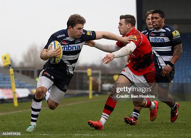 Will Addison hands off the tackle of Nick Scott of London Welsh to score a try during the Aviva Premiership match between London Welsh and Sale...