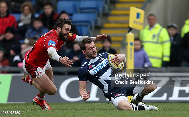 Mark Cueto of Sale slides over to score under pressure from Seb Stegmann of London Welsh during the Aviva Premiership match between London Welsh and...