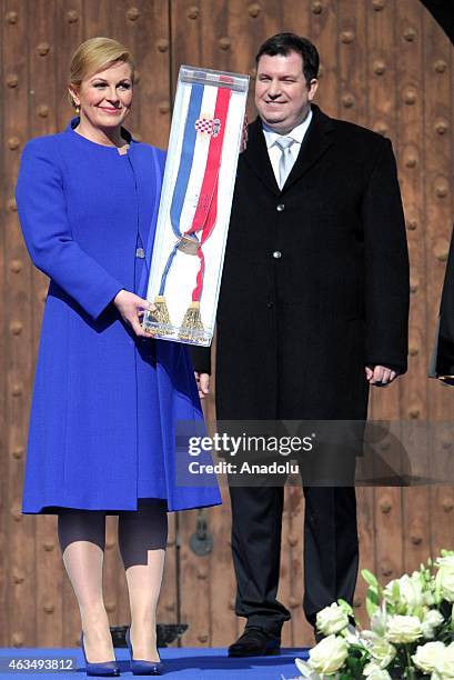 Croatia's new president Kolinda Grabar-Kitarovic holds Presidential sash during the swearing-in ceremony at St. Marc square in Zagreb, Croatia, on...