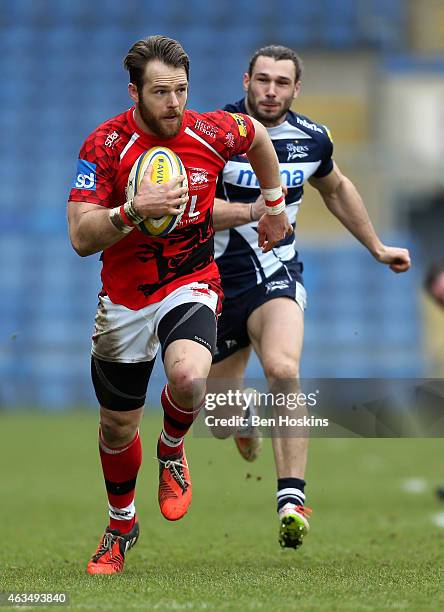 Seb Jewell of London Welsh makes a break ahead of Tom Arscott of Sale during the Aviva Premiership match between London Welsh and Sale Sharks at...