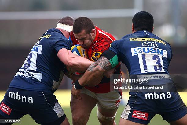 Carl Kirwan of London Welsh is held in the tackle by Sale's Vadim Cobilas and Johnny Leota during the Aviva Premiership match between London Welsh...