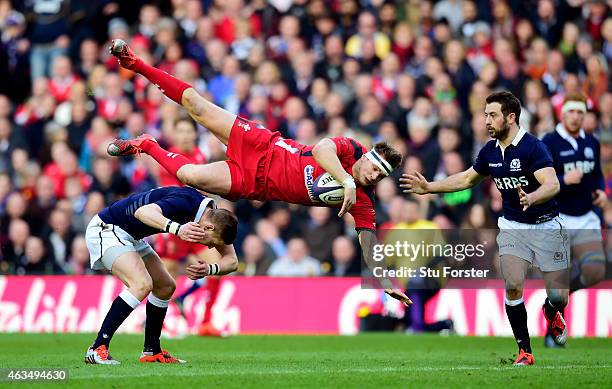 Dan Biggar of Wales is taken out in the air by Finn Russell of Scotland during the RBS Six Nations match between Scotland and Wales at Murrayfield...