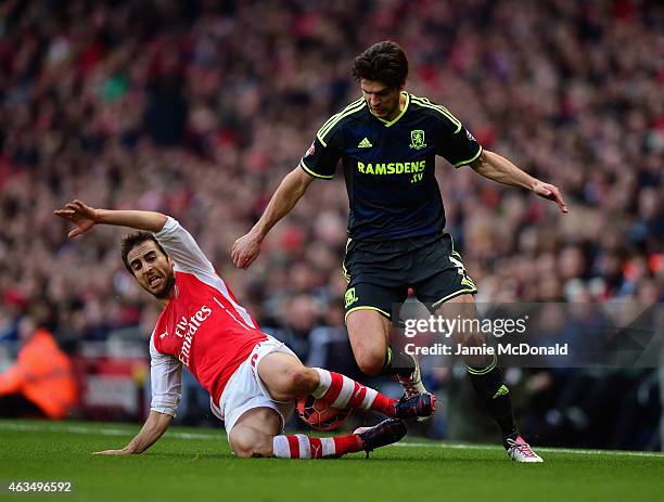 Mathieu Flamini of Arsenal slides in to tackle George Friend of Middlesbrough during the FA Cup fifth round match between Arsenal and Middlesbrough...