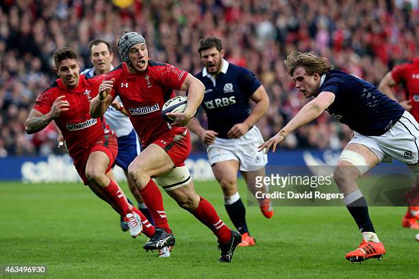 Jonathan Davies of Wales goes past Richie Gray of Scotland to score his team's second try during the RBS Six Nations match between Scotland and Wales...