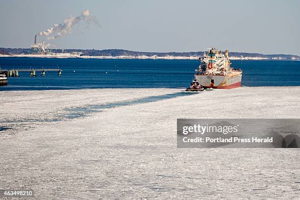 Tugboat escorts the cargo ship Anette out of the ice filled river and into open water in Casco Bay Friday, February 13, 2015.