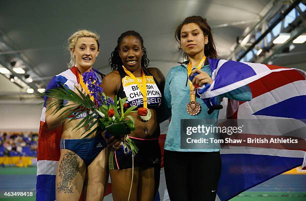 Lucy Hatton of Great Britain, Serita Solomon of Great Britain and Yasmin Miller of Great Britain pose on the podium after the womens 60m hurdles...