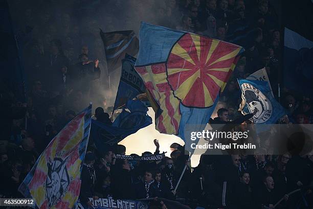 Supporters of Paderborn handle fireworks during the Bundesliga match between Hannover 96 and SC Paderborn 07 at HDI-Arena on February 15, 2015 in...