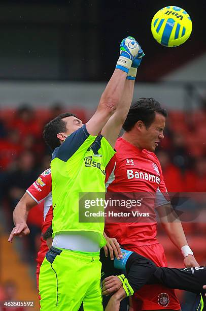 Aaron Galindo of Toluca struggles for the ball with Agustin Marchesin goalkeeper of Santos Laguna during a match between Toluca and Santos Laguna as...