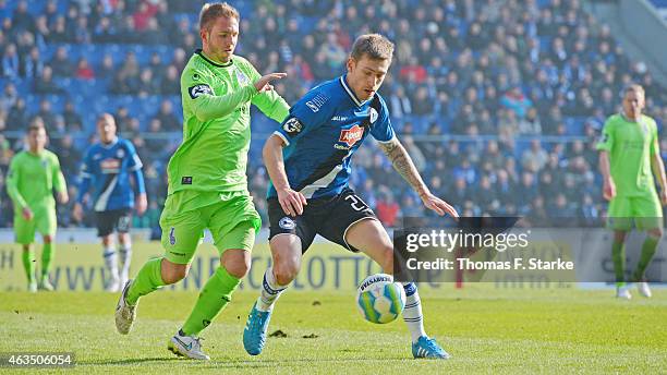 Pierre De Wit of Duisburg tackles Manuel Junglas of Bielefeld during the Third League match between Arminia Bielefeld and MSV Duisburg at Schueco...