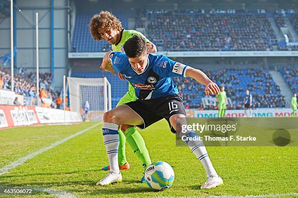 Rolf Feltscher of Duisburg tackles Dennis Mast of Bielefeld during the Third League match between Arminia Bielefeld and MSV Duisburg at Schueco Arena...