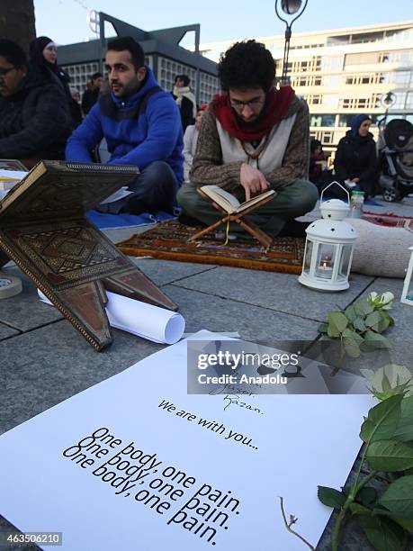 Demonstrators read holy Quran as they gather at Breitscheidplatz square to protest against the Chapel Hill shooting, in Berlin, Germany on February...