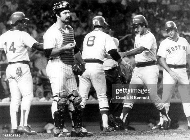 Fred Lynn of the Boston Red Sox is congratulated from his teammates Carl Yastrzemski, Jim Rice and Bob Bailey after hitting a three-run homerun as...