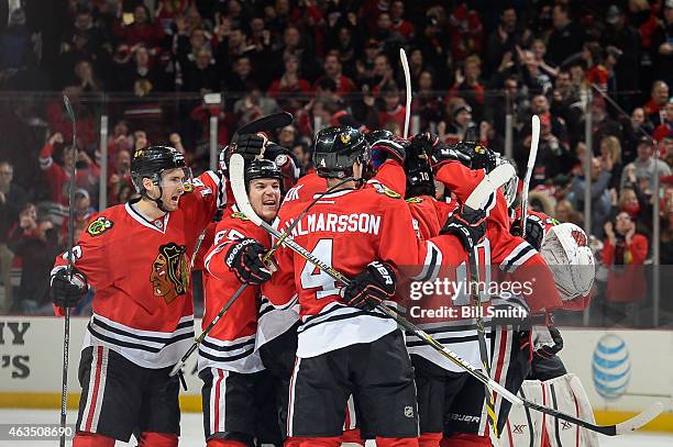 Marcus Kruger and Andrew Shaw of the Chicago Blackhawks celebrate with the team after defeating the Pittsburgh Penguins 2-1 during the NHL game at...