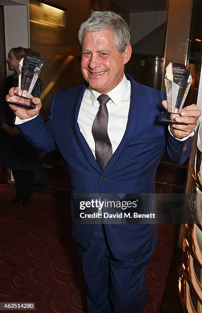 Producer Sir Cameron Mackintosh poses with the Best Musical Revival and Best West End Musical awards won by "Miss Saigon" in the press room at the...