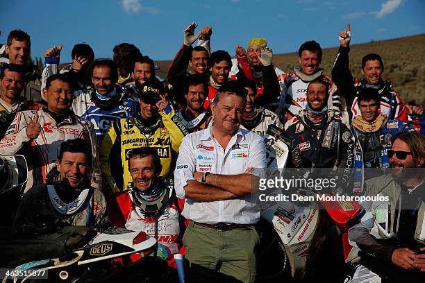 Rally director Etienne Lavigne poses with the motorbike and quadbike riders as they get ready to compete in stage 13, the final leg on the way to...