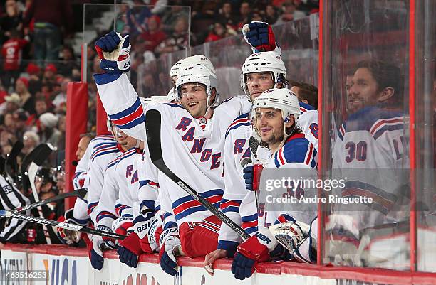 Derick Brassard of the New York Rangers raises his arms to celebrate a second period goal against the Ottawa Senators with teammates Benoit Pouliot...