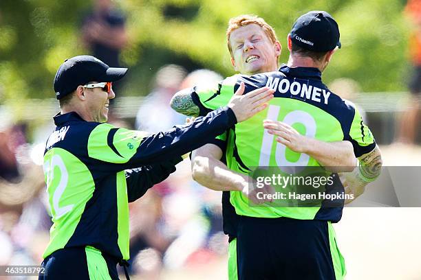 Kevin O'Brien of Ireland celebrates with teammates John Mooney and Niall O'Brien after taking the wicket of Dwayne Smith of the West Indies during...
