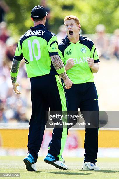 Kevin O'Brien of Ireland celebrates with teammate John Mooney after taking the wicket of Dwayne Smith of the West Indies during the 2015 ICC Cricket...