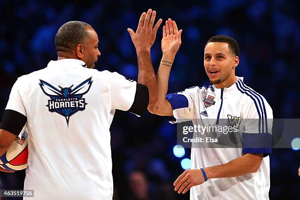 Stephen Curry of the Golden State Warriors and of the Western Conference jokes with his father and NBA Legend Dell Curry during the Degree Shooting...