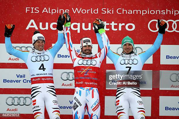 Silver medalist Fritz Dopfer of Germany, gold medalist Jean-Baptiste Grange of France, and bronze medalist Felix Neureuther of Germany celebrate on...