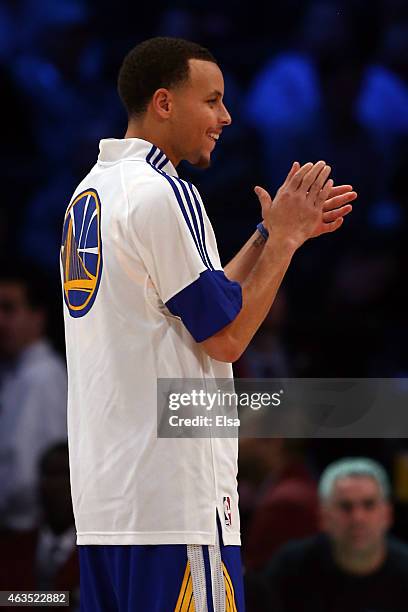 Stephen Curry of the Golden State Warriors and the Western Conference looks on during the Degree Shooting Stars Competition as part of the 2015 NBA...