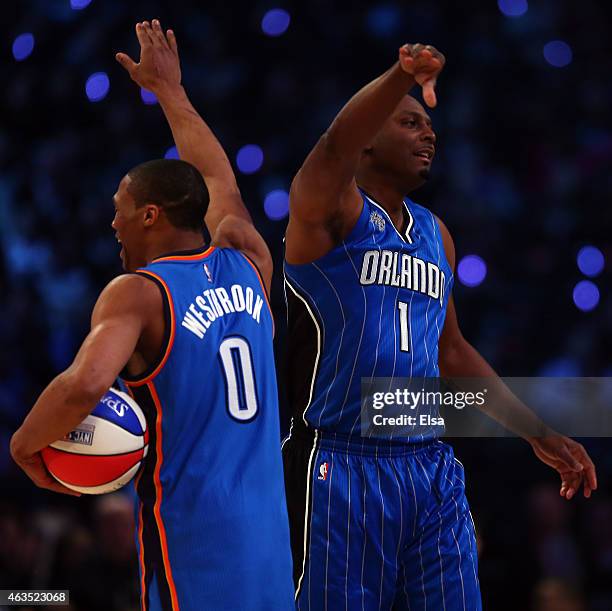 Russell Westbrook of the Oklahoma City Thunder and the Western Conference high-fives NBA legend Anfernee "Penny" Hardaway during the Degree Shooting...