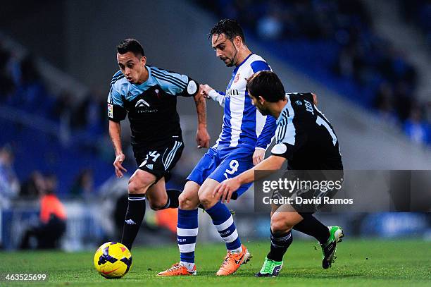 Sergio Garcia of RCD Espanyol duels for the ball with Fabian Orellana and Jonny Castro of RC Celta de Vigo during the La Liga match between RCD...