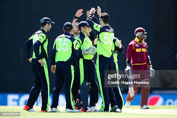 George Dockrell of Ireland celebrates with teammates after taking the wicket of Marlon Samuels of the West Indies during the 2015 ICC Cricket World...