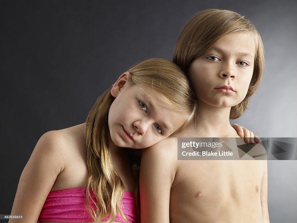 Portrait of young sister and brother in studio