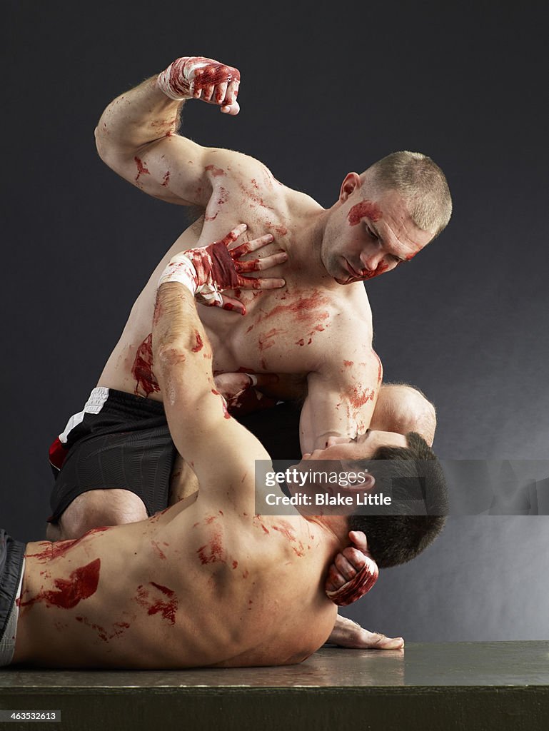 Two men fighting and bloody
