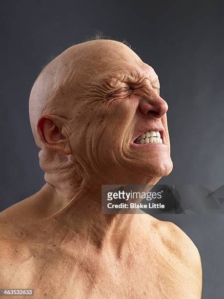 man clenching teeth - bald man stock pictures, royalty-free photos & images