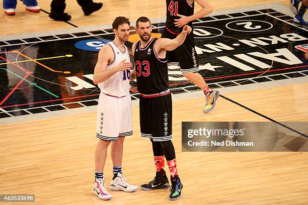 Marc Gasol of the Western Conference All-Stars and Pau Gasol of the Eastern Conference All-Stars talk during the 2015 NBA All-Star Game as part of...
