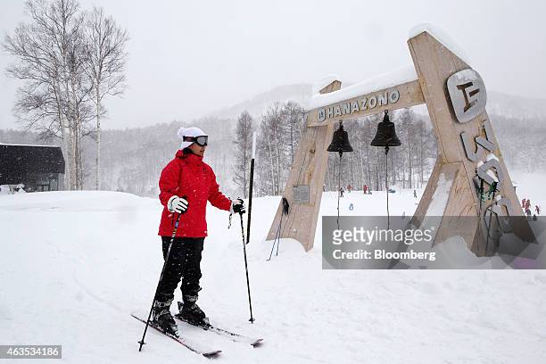 Skier passes bells displayed in the base area of the Niseko Hanazono resort, operated by Nihon Harmony Resorts KK, in Kutchan, Hokkaido, Japan, on...