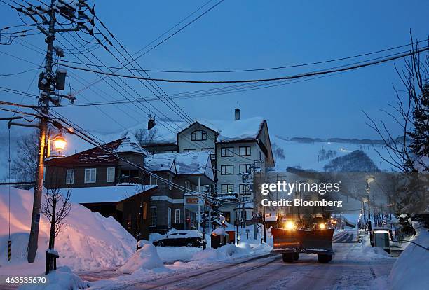 Snow plow drives on a street in the Hirafu area of Kutchan, Hokkaido, Japan, on Sunday, Feb. 15, 2015. The ski and snowboard resort, majority owned...