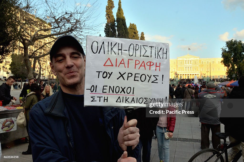 A demonstrator holds a picket with a message of support for...
