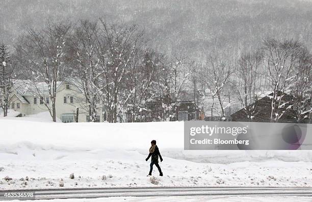 Woman walks through the Hirafu area of Kutchan, Hokkaido, Japan, on Saturday, Feb. 14, 2015. Japan had a record number of foreign visitors in 2014,...